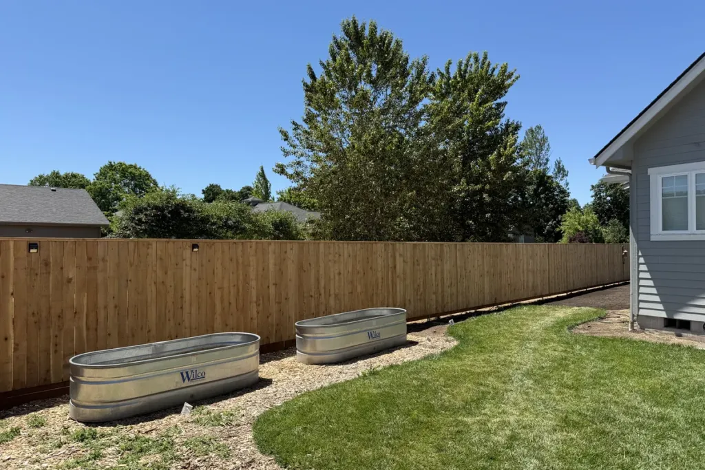 Cedar fence corner run around a new-build back garden