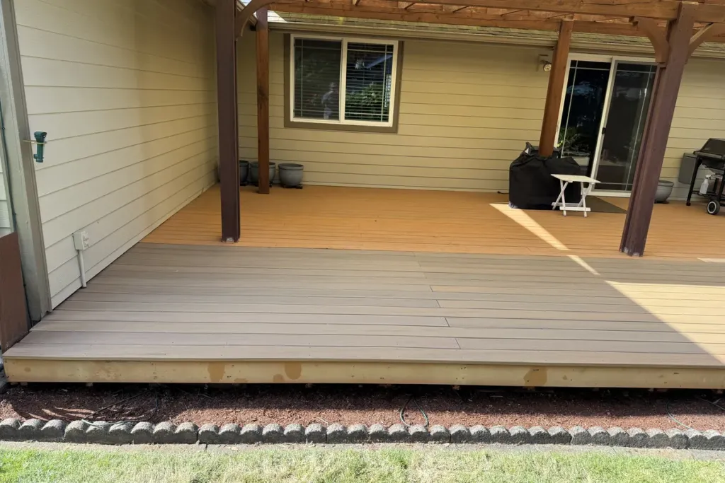 Finished two-tone composite deck under a patio cover built by Tekton Construction