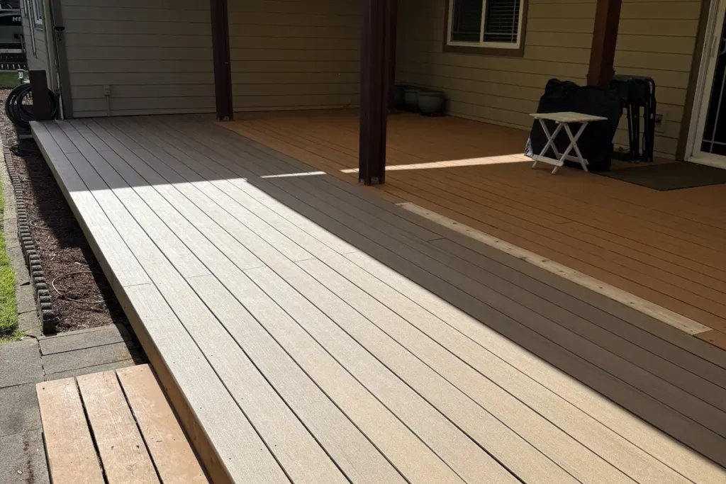 Composite deck under a patio cover looking out to the garden