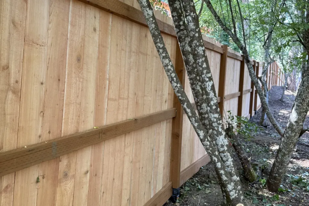 New cedar privacy fence with properly set posts built by Tekton Construction